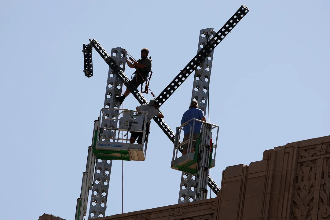 Workers prepare to dismantle a large X logo on the roof of X headquarters on July 31st, 2023, in San Francisco, California.